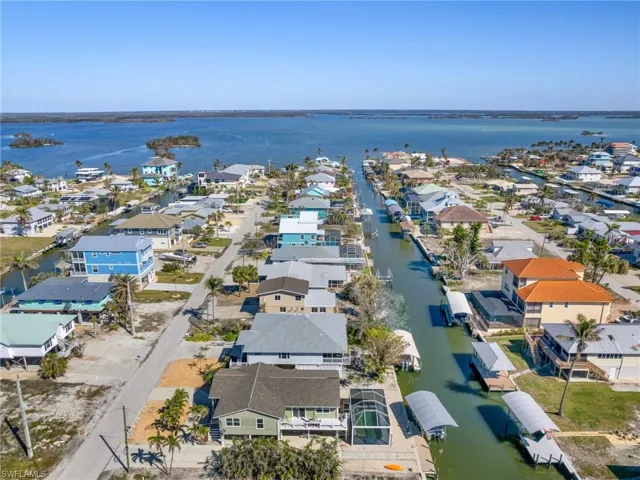 Aerial view of residential area featuring a nearby body of water