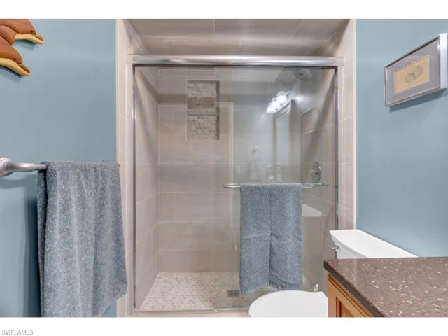 Full bath with vanity and a shower stall