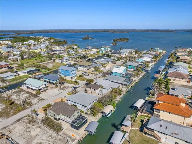 View of property location featuring a nearby body of water and nearby suburban area
