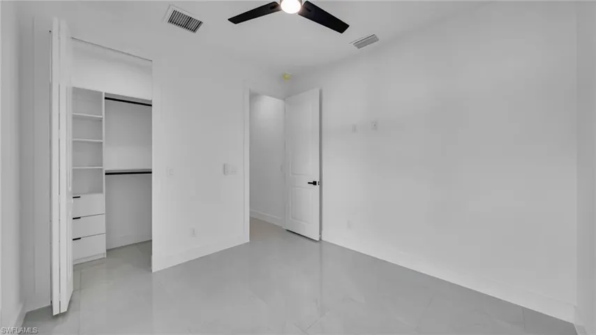 Unfurnished bedroom featuring a closet and a ceiling fan