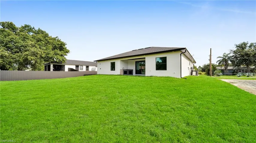 Rear view of property with stucco siding