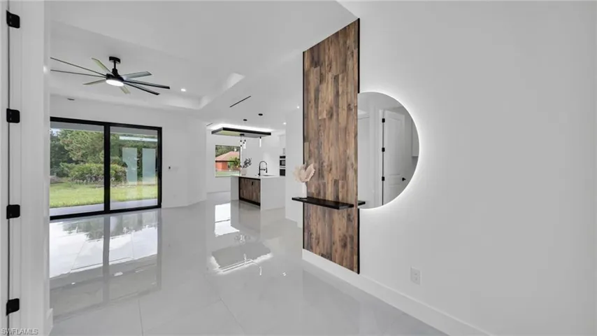 Spare room with light tile patterned floors, a ceiling fan, recessed lighting, and a raised ceiling