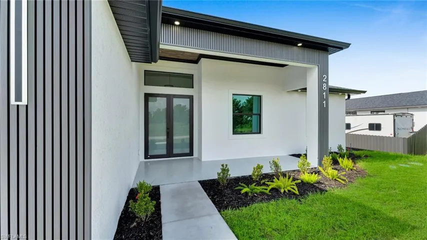 Entrance to property with stucco siding