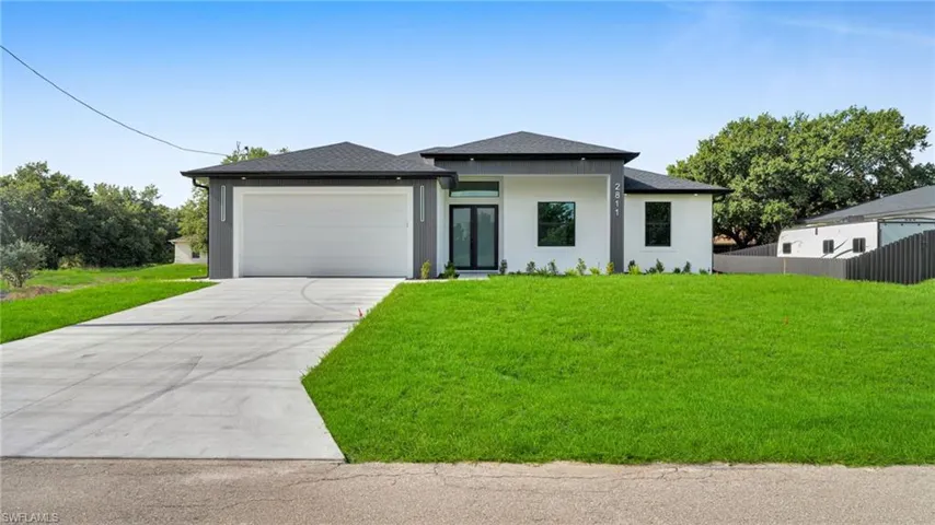 Prairie-style house with roof with shingles, concrete driveway, an attached garage, and stucco siding