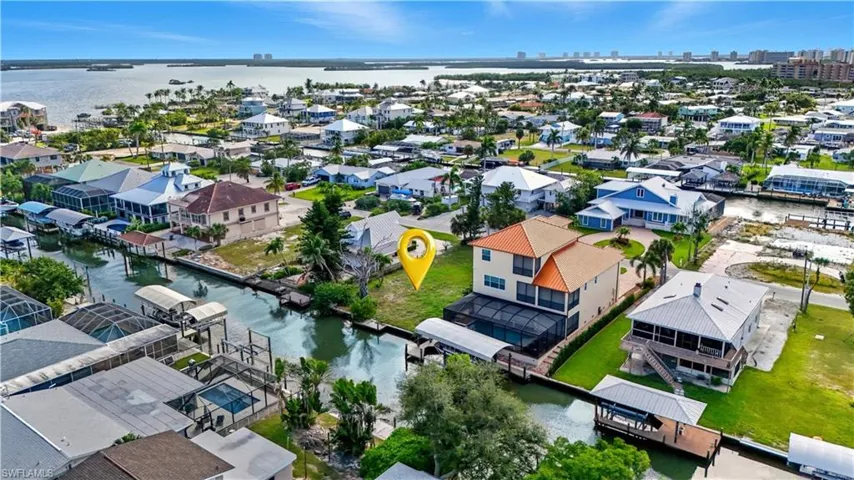 Aerial view of residential area featuring a large body of water - Virtually Edited Image