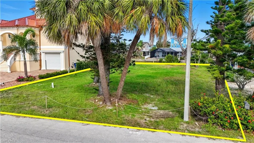 View of front of house featuring stucco siding and a front lawn - Virtually Edited Image