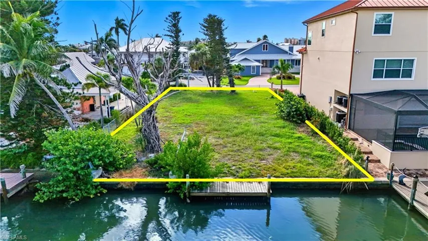 Aerial view of residential area featuring a large body of water - Virtually Edited Image