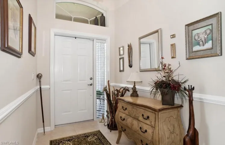 Foyer entrance featuring light tile patterned flooring