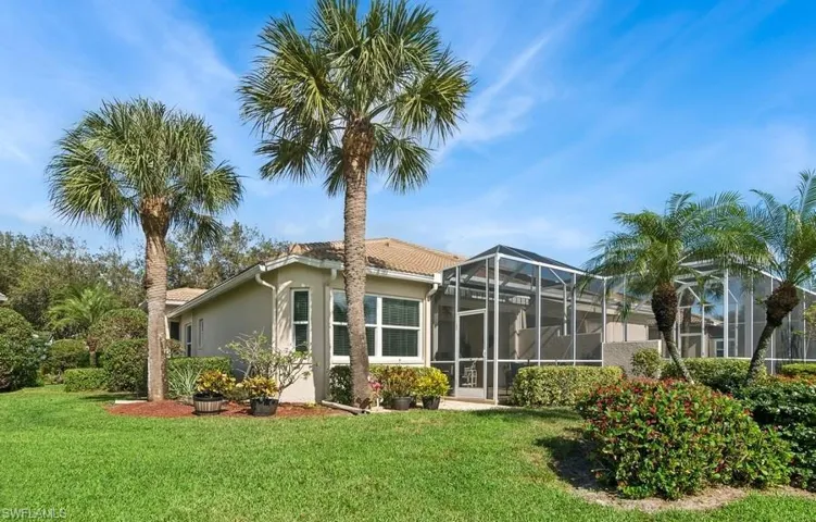 Back of house featuring screened in lanai with ROOM FOR A POOL and a lawn with view of Golf Course