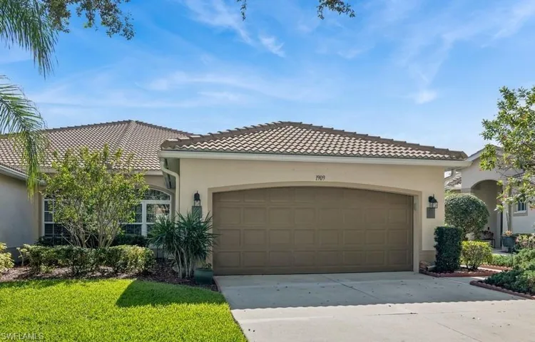 Mediterranean / spanish house with a garage and a front lawn