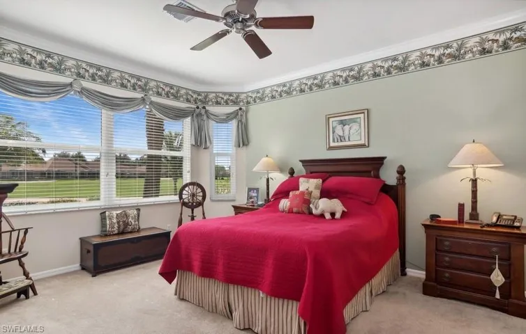 Bedroom featuring crown molding, light carpet, and ceiling fan