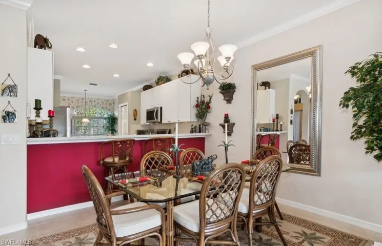 Dining area featuring crown molding, light tile patterned floors, and a chandelier