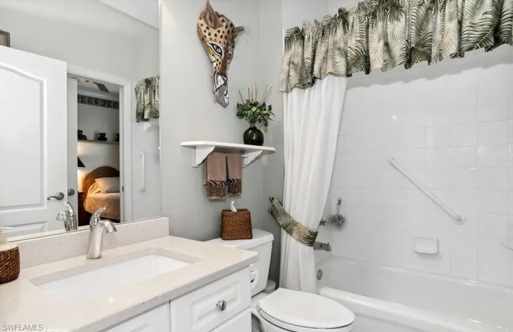 Refurbished Full Guest bathroom featuring vanity, comfort toilet, and shower / bath combo with shower curtain