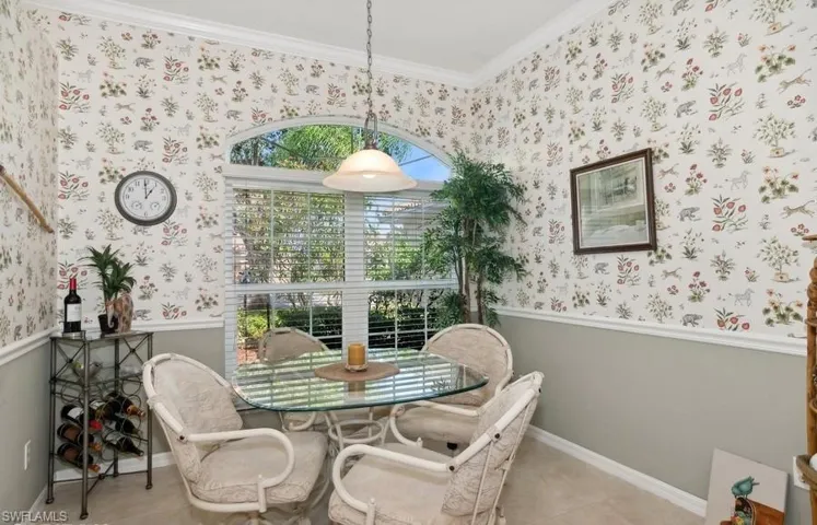 Dining area featuring crown molding and light tile patterned floors