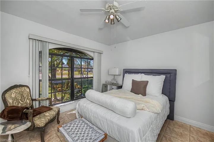 Bedroom with tile patterned floors and a ceiling fan