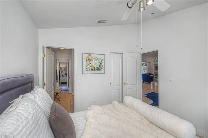 Bedroom with lofted ceiling and a ceiling fan