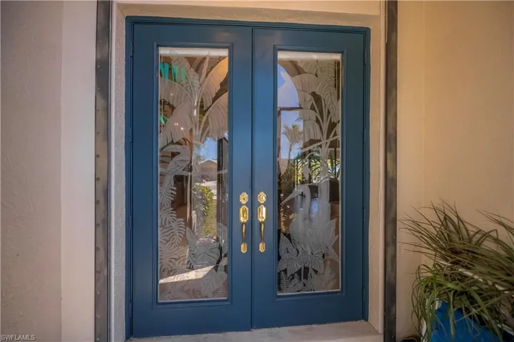 Entrance to property featuring french doors and stucco siding