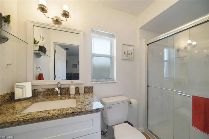 Full bath with a stall shower and vanity