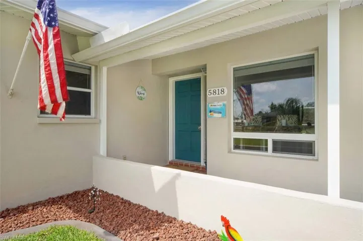 Entrance to property with stucco siding
