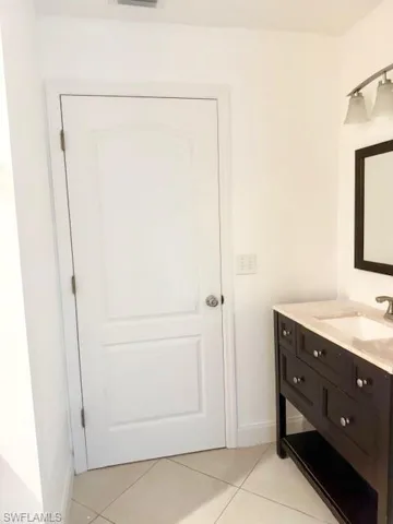 This convenient second bathroom serves as a private ensuite to one of the bedrooms. It carries the home’s light-filled aesthetic through, offering a clean and refreshed feel for guests or residents.