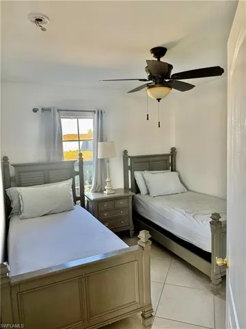 Room featuring neutral wall tones, a ceiling fan with integrated lighting, and tile flooring