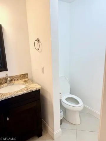 The primary bathroom features a spacious layout with a large walk-in shower and a double vanity sink, offering both comfort and functionality.