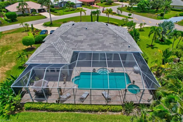 Rear of home shows extended pool cage