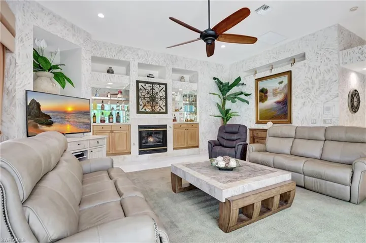 Family room with gas fireplace and built in bar