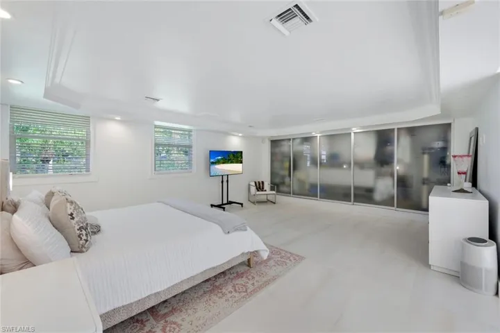 Spacious Primary bedroom with tray ceilings, built in custom closet shelving