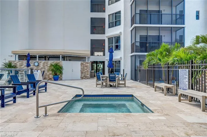 View of pool with a hot tub, a pool, outdoor dining space, and patio surround