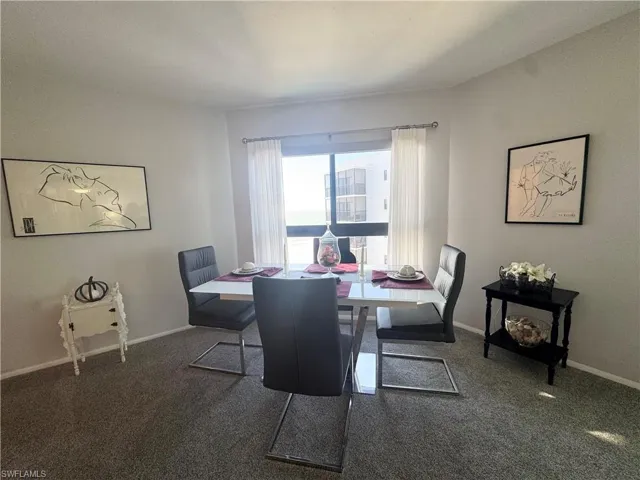 Dining space featuring  carpet and baseboards with views out to the Gulf of Mexico
