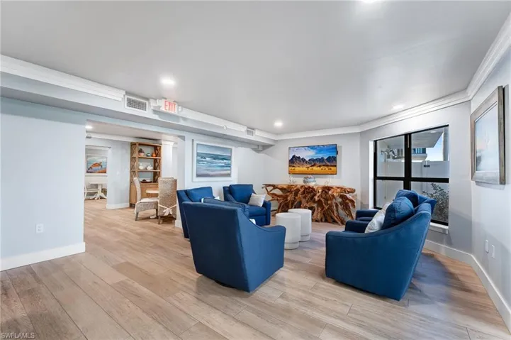 Community area with light wood-style flooring, recessed lighting, and crown molding