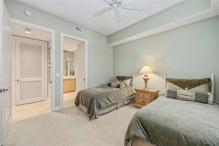 Bedroom with carpet flooring, ceiling fan, and ensuite bathroom