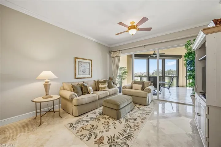 Living area featuring crown molding and ceiling fan