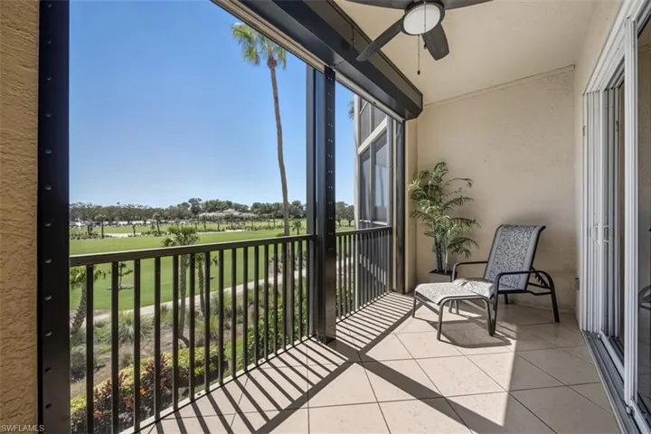 Balcony featuring a ceiling fan, a sunroom, and view of golf course