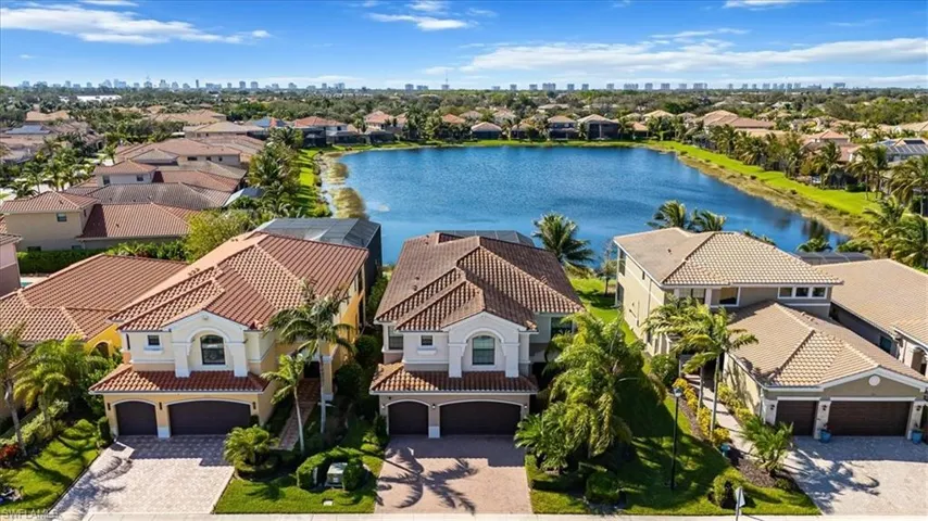 Aerial view of residential area with a large body of water and city skyline