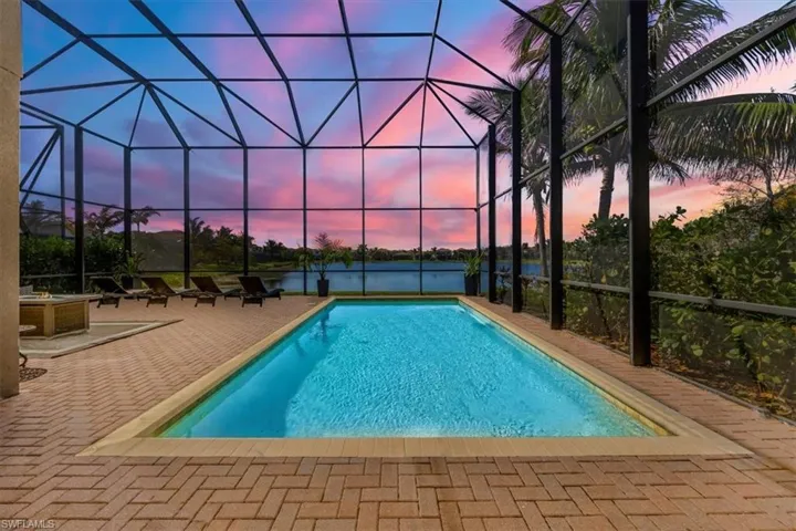 Swimming pool with a patio area and glass enclosure