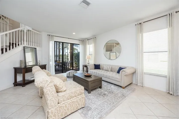 Living area with light tile patterned floors and baseboards