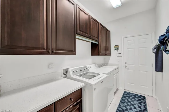 Spacious laundry room with a sink and plenty of counter space.