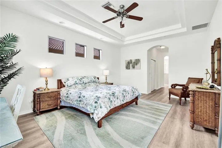 A tray ceiling and soft natural light highlight this space.