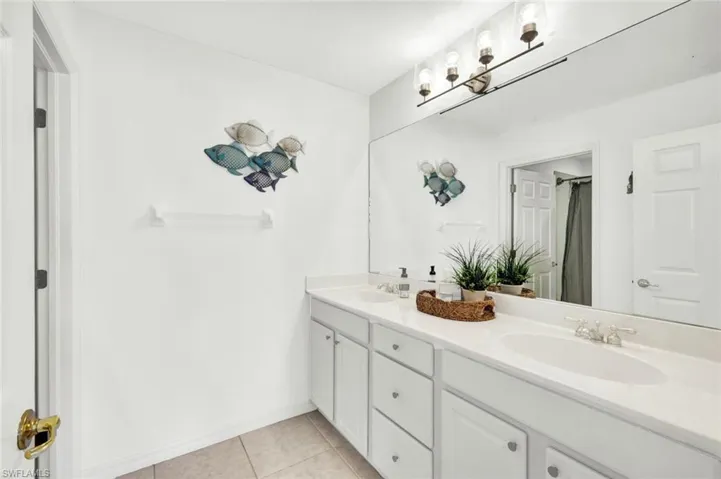 Guest bathroom featuring dual sinks and ample counter space.