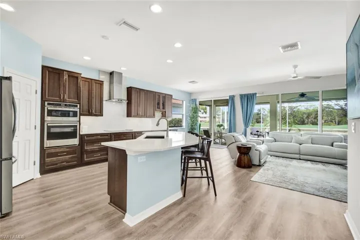Redesigned kitchen features a breakfast ample cabinetry, quartz countertops and generous prep space.