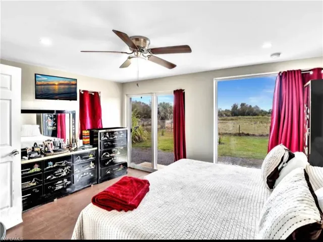 Bedroom featuring access to exterior, ceiling fan, and wood-type flooring
