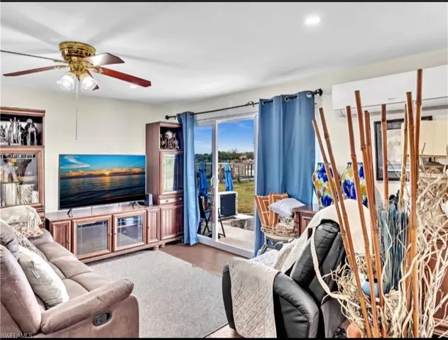 Living room featuring ceiling fan and wood-type flooring