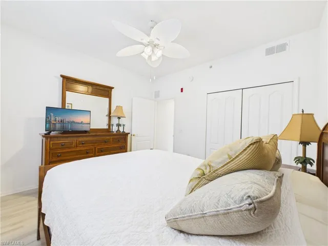 Bedroom with a closet, a ceiling fan, and wood finished floors