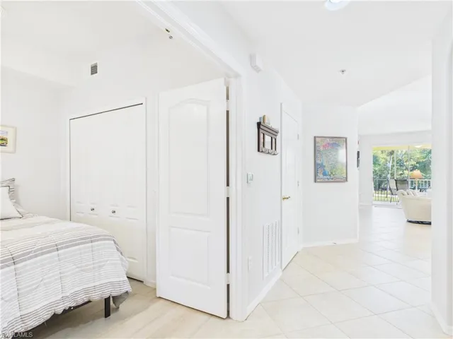 Bedroom with a closet and light tile patterned flooring