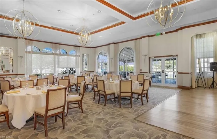 Dining room featuring a chandelier, a tray ceiling, ornamental molding, french doors, and wood finished floors