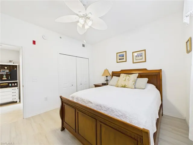 Bedroom with a closet, light wood-type flooring, and ceiling fan