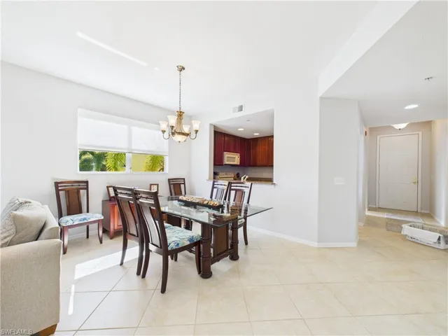 Dining room featuring light tile patterned flooring and a chandelier