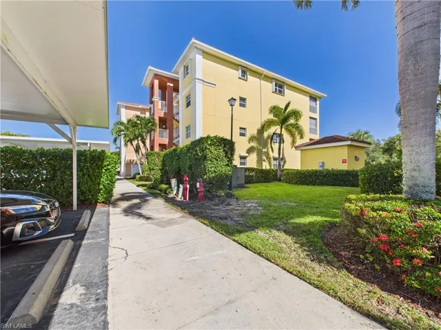 View of property with uncovered parking